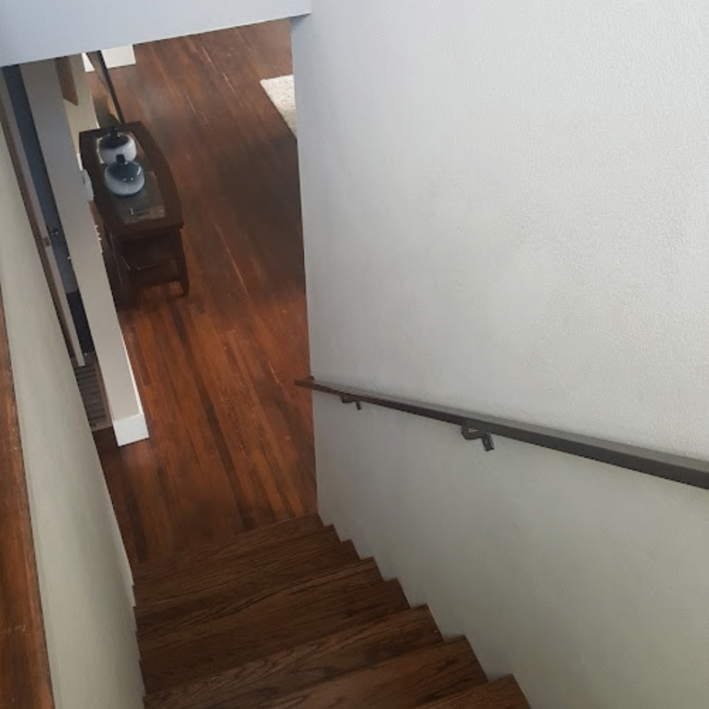 Basement stairs renovation with new flooring and painted walls by LJ Handyman Services in Denver, Colorado