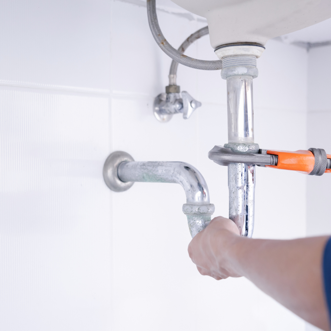 Skilled plumber fixing sink pipes during plumbing repair service in Lakewood Denver